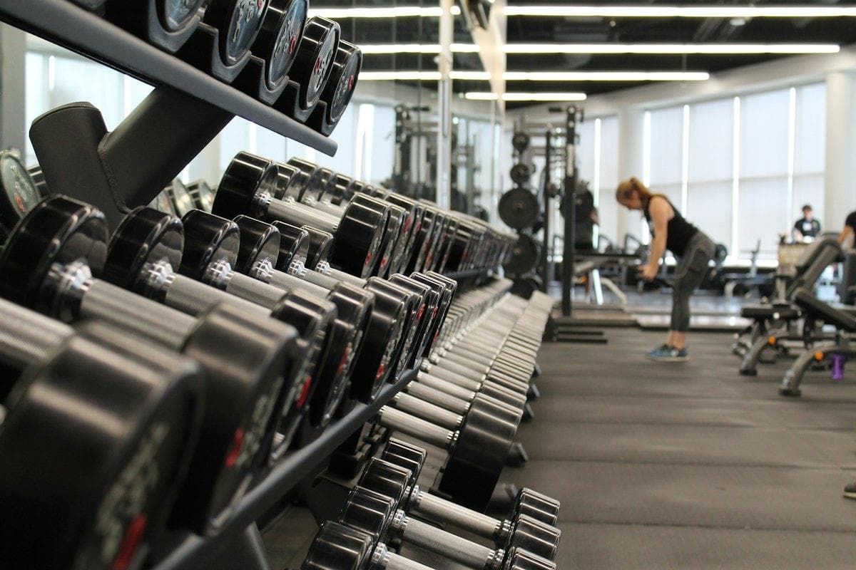 Unsplash Gym floor with dumbbell racks